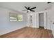 Bedroom featuring hardwood floors, ceiling fan, and an attached bathroom at 1475 3Rd Ave, Deland, FL 32724