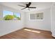 Cozy bedroom with wood floors, ceiling fan, and windows offering plenty of natural light at 1475 3Rd Ave, Deland, FL 32724