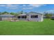 Inviting single-story home with a lush green lawn and a charming front yard garden at 1475 3Rd Ave, Deland, FL 32724