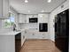 Modern kitchen with stainless steel appliances, white countertops and cabinets, and wood flooring at 1475 3Rd Ave, Deland, FL 32724