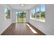 Spacious living room with wood floors and windows viewing the backyard at 1475 3Rd Ave, Deland, FL 32724