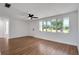 Bright living room featuring wood floors, a ceiling fan, and a large window at 1475 3Rd Ave, Deland, FL 32724
