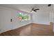 Bright living room with wood floors, neutral walls, a ceiling fan, and natural light at 1475 3Rd Ave, Deland, FL 32724