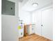 Utility room featuring water heater, utility sink, and storage cabinet at 1475 3Rd Ave, Deland, FL 32724