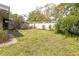 View of the back yard, with a block wall, and lawn at 2908 Maplewood Ave, Lakeland, FL 33803