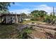 View of the back yard, with a shed, garden beds and a lawn at 2908 Maplewood Ave, Lakeland, FL 33803
