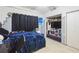The bedroom includes a closet with shelves, a ceiling fan, and curtained windows at 2908 Maplewood Ave, Lakeland, FL 33803