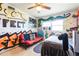 Bedroom with graffiti-style artwork on the walls, a futon, and window unit at 2908 Maplewood Ave, Lakeland, FL 33803