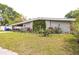 A single story home with xeriscape landscaping including succulents and cacti in the front yard at 2908 Maplewood Ave, Lakeland, FL 33803