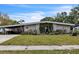 Charming single-story home with a covered carport and xeriscaped front yard with cacti and succulents at 2908 Maplewood Ave, Lakeland, FL 33803
