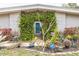 Inviting front entrance with a green door framed by lush greenery, surrounded by potted plants and cacti at 2908 Maplewood Ave, Lakeland, FL 33803