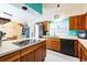 Bright kitchen with stainless steel appliances, white countertops, and wood cabinets at 2908 Maplewood Ave, Lakeland, FL 33803