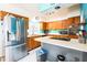 Bright kitchen with stainless steel appliances, white countertops, and wood cabinets at 2908 Maplewood Ave, Lakeland, FL 33803