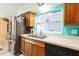 Traditional kitchen featuring a stainless steel fridge and sink with white counters at 2908 Maplewood Ave, Lakeland, FL 33803