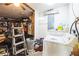 The Laundry room includes a washer, dryer, storage shelving and other items at 2908 Maplewood Ave, Lakeland, FL 33803