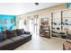 Comfortable living room featuring a gray couch, bright blue accent wall, and lots of natural light at 2908 Maplewood Ave, Lakeland, FL 33803