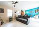 Sunlit living room featuring a gray couch, bright blue accent wall, and lots of natural light at 2908 Maplewood Ave, Lakeland, FL 33803