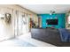 Comfortable living room featuring a gray couch, bright blue accent wall, and lots of natural light at 2908 Maplewood Ave, Lakeland, FL 33803