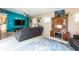 Cozy living room with a gray couch, blue accent wall, vintage cabinet and blue area rug at 2908 Maplewood Ave, Lakeland, FL 33803