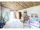 Unfinished room with exposed insulation, an unpainted wall, and various construction materials at 2908 Maplewood Ave, Lakeland, FL 33803