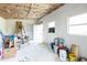 Room with white walls, exposed ceiling insulation, and building materials inside at 2908 Maplewood Ave, Lakeland, FL 33803