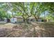 Lush backyard with mature trees and shed at 3365 Bahama Ct, Lake Wales, FL 33898