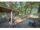 Back patio and backyard featuring mature shady trees at 3365 Bahama Ct, Lake Wales, FL 33898