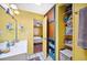Bright bathroom featuring a white vanity, colorful walls, open closet, and an adjacent bedroom at 3365 Bahama Ct, Lake Wales, FL 33898