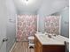 Cozy bathroom featuring a patterned shower curtain and wood-look flooring at 3365 Bahama Ct, Lake Wales, FL 33898