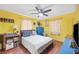 Bright bedroom with yellow walls, a bed, side tables, and decorative touches for a cheery feel at 3365 Bahama Ct, Lake Wales, FL 33898