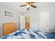 Comfortable bedroom with a ceiling fan, dresser, and view into the attached bathroom and walk-in closet at 3365 Bahama Ct, Lake Wales, FL 33898
