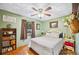 Charming bedroom with hardwood floors, a ceiling fan, a comfortable bed, and tasteful decor at 3365 Bahama Ct, Lake Wales, FL 33898