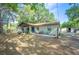 Single-story home with brick exterior, covered entry, mature trees, and long driveway for plenty of parking at 3365 Bahama Ct, Lake Wales, FL 33898