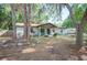 Quaint single-story home featuring a brick exterior, covered entry, and mature landscaping for curb appeal at 3365 Bahama Ct, Lake Wales, FL 33898