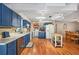 Spacious kitchen featuring blue cabinets, updated countertops and stainless steel appliances with open floorplan at 3365 Bahama Ct, Lake Wales, FL 33898