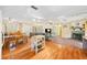 Open concept living space with wood floors, a dining area, and a brick fireplace at 3365 Bahama Ct, Lake Wales, FL 33898