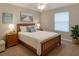 Cozy bedroom with a wood-framed bed, soft lighting, and serene decor at 3533 Roanoke St, The Villages, FL 32162