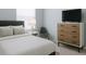 Comfortable bedroom with a plush bed, sleek dresser, and minimalist design at 3533 Roanoke St, The Villages, FL 32162