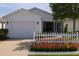 Charming home featuring a well-maintained front yard with a delightful flower bed and a white picket fence at 3533 Roanoke St, The Villages, FL 32162