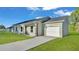 Stylish home with a one-car garage and a concrete driveway on a sunny day at 534 S Perry Ave, Fort Meade, FL 33841