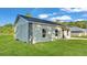 Side view of a cozy home with stone accents and a lush green lawn at 534 S Perry Ave, Fort Meade, FL 33841