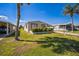 Inviting single-story home with a well-manicured lawn and palm trees, located in a friendly community at 65 Joppa Dr, Winter Haven, FL 33884