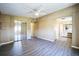 Main bedroom with wood-look floors, ceiling fan, and en-suite bathroom and closet access at 65 Joppa Dr, Winter Haven, FL 33884