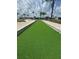 Close up of a mini golf hole showcasing the pristine green turf and the careful stone edging at 65 Joppa Dr, Winter Haven, FL 33884