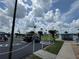 Community parking area with several golf carts parked, along with a basketball court and grassy areas at 65 Joppa Dr, Winter Haven, FL 33884