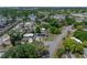 Birds eye view of a neighborhood featuring tree-lined streets and a single-Gathering home with solar panels at 3928 Cherry Way, Lakeland, FL 33805