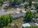 Aerial view of a well-kept home showcasing its roof, yard, and surrounding greenery at 3928 Cherry Way, Lakeland, FL 33805