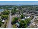 Wide aerial shot featuring a neighborhood with a swimming pool and a single-Gathering home with solar panels at 3928 Cherry Way, Lakeland, FL 33805
