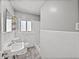 Bathroom featuring a white-tiled shower and floors, with a standard toilet at 3928 Cherry Way, Lakeland, FL 33805