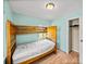 A cozy bedroom featuring wood-frame bunk beds and aqua colored walls at 3928 Cherry Way, Lakeland, FL 33805